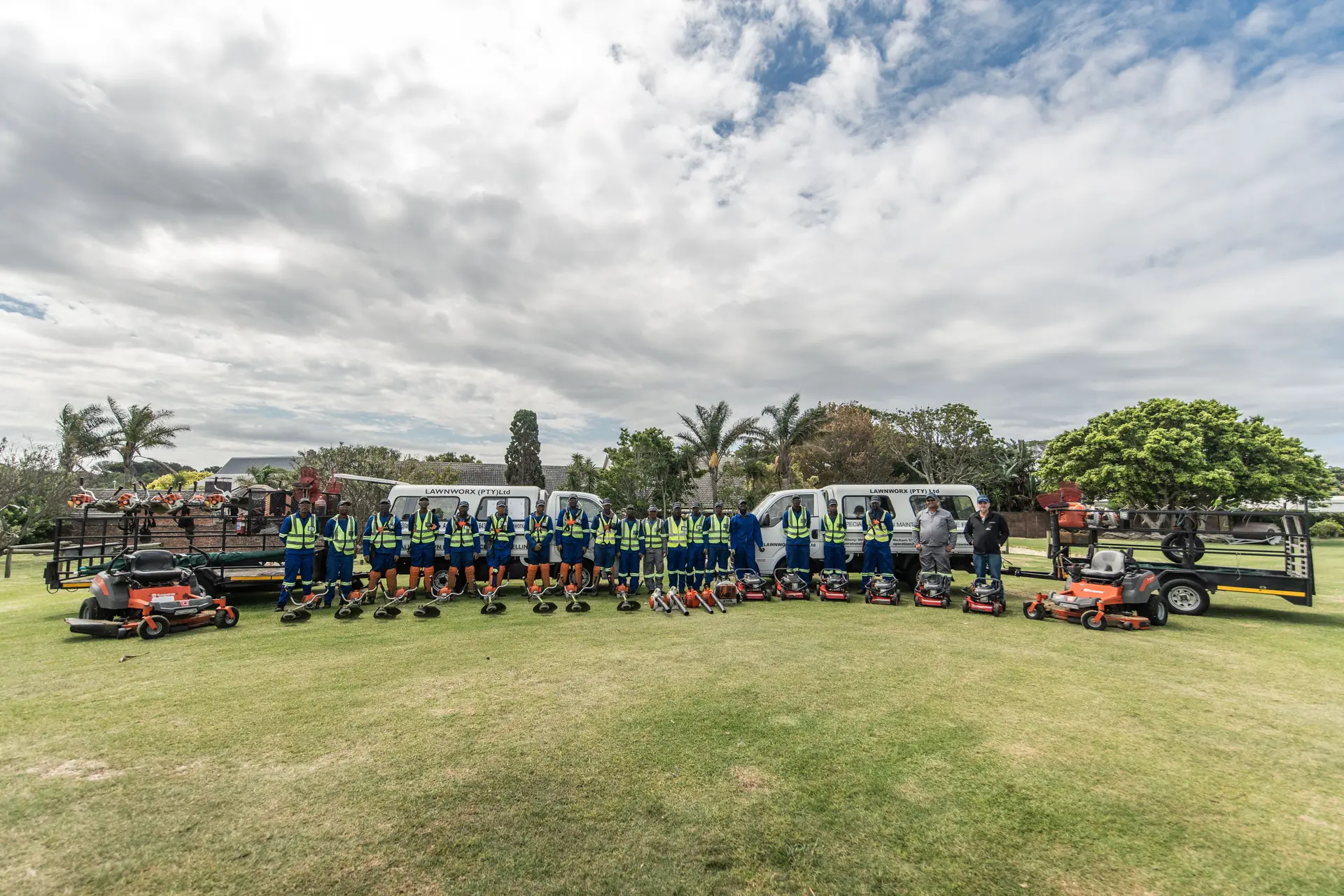 The full Lawnworx team with their vehicles and grounds maintenance equipment
