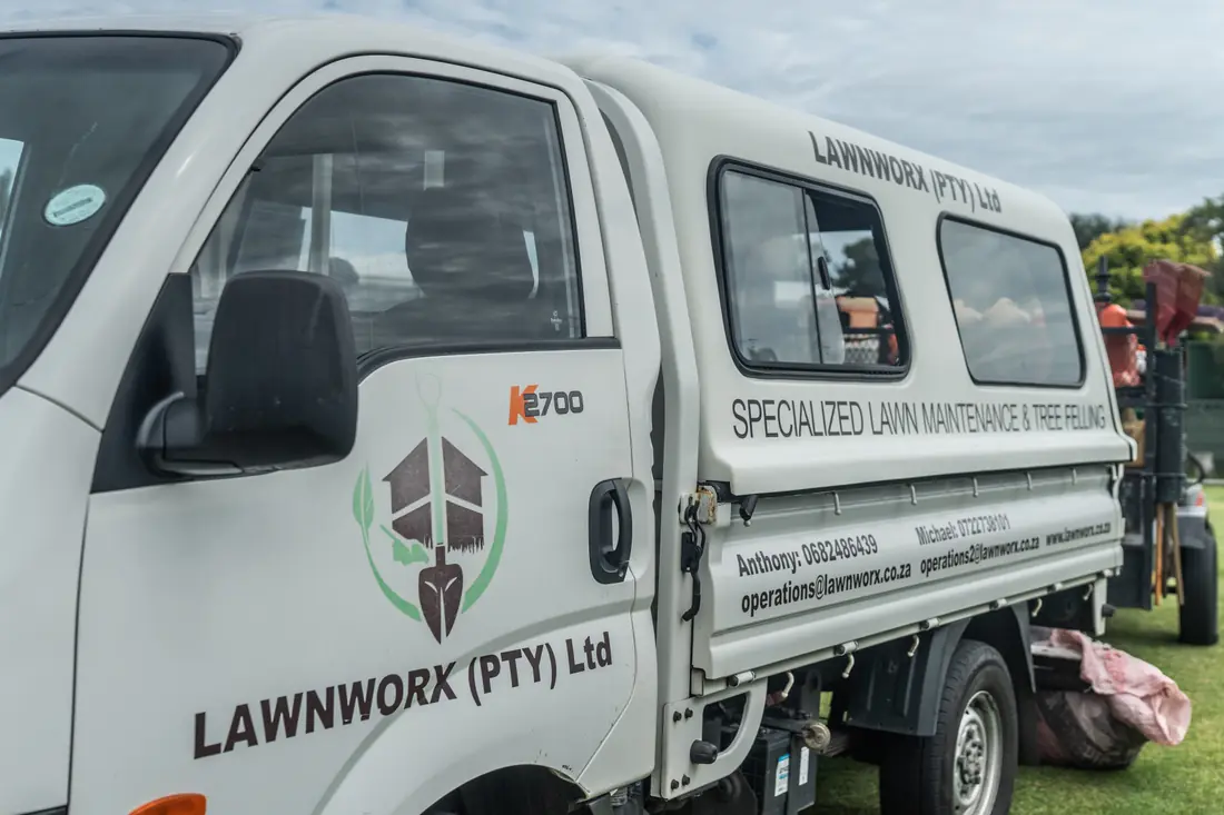 Branded Lawnworx vehicle and trailer used to bring equipment to client properties